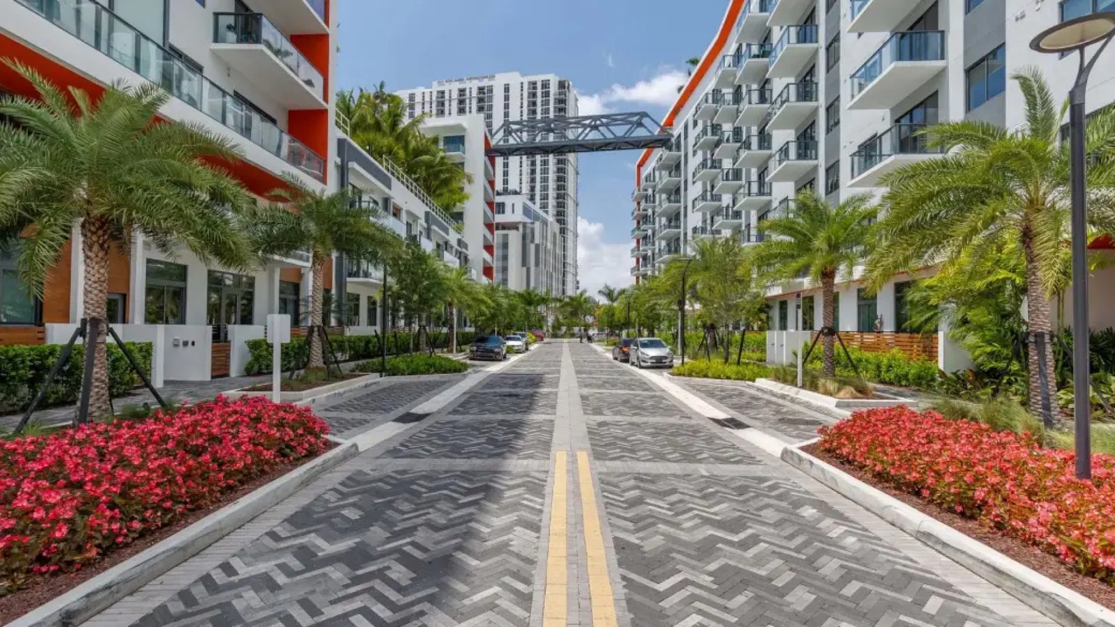 AMLI Midtown: the entrance street, with planters and the pedestrian bridge.
